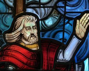Stained Glass window of Jesus with his hand raised, calming the storm